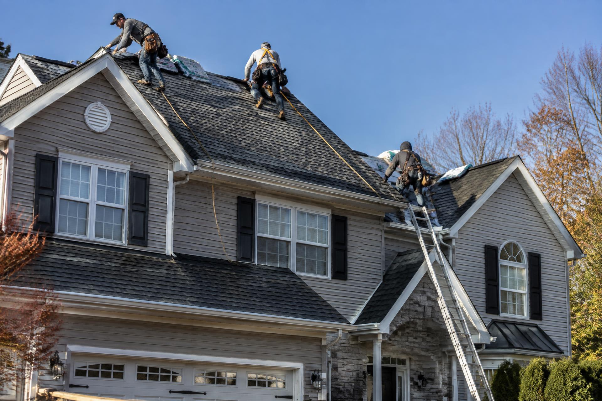 Quality Roofing crew installing a new shingle roof on a New Jersey home